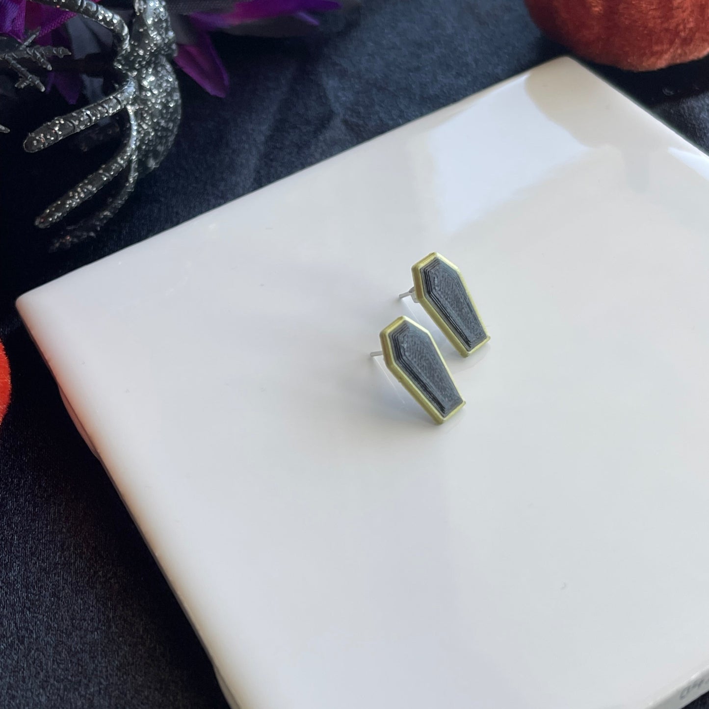 Halloween studs on a white surface with decorative elements in the background