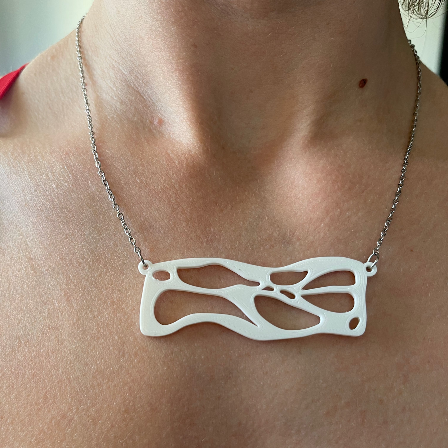 Necklace with a unique pendant worn by a person